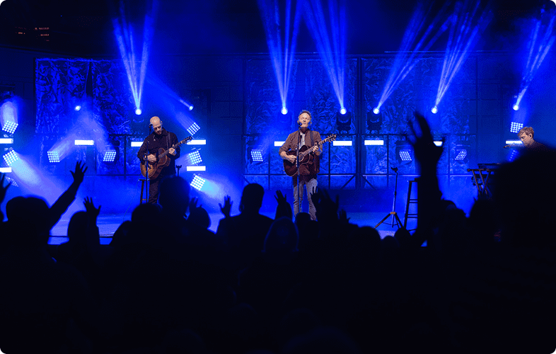 A group of people on stage playing guitar.